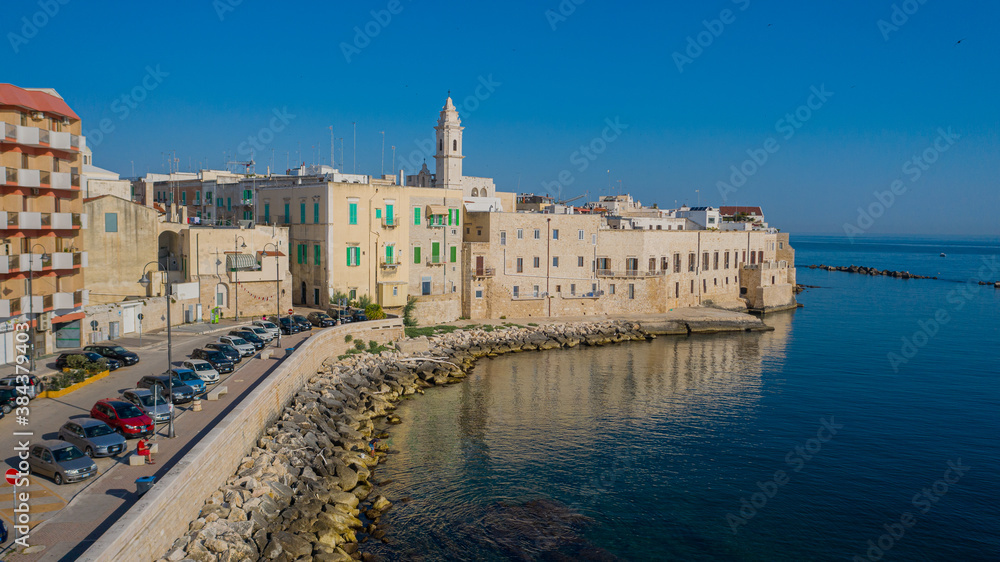 Beautiful panoramic aerial view photo from flying drone on Molfetta waterfront and the old town from a great height.Port with ships and yachtsand the Molfetta new city at sunrise.Apulia,Italy (Series)