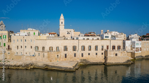 Beautiful panoramic aerial view photo from flying drone on Molfetta waterfront and the old town from a great height.Port with ships and yachtsand the Molfetta new city at sunrise.Apulia,Italy (Series) photo