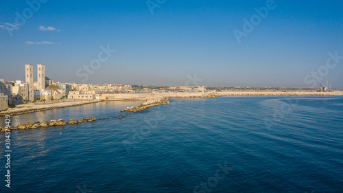 Beautiful panoramic aerial view photo from flying drone on Molfetta waterfront and the old town from a great height.Port with ships and yachtsand the Molfetta new city at sunrise.Apulia,Italy (Series) © Sandis