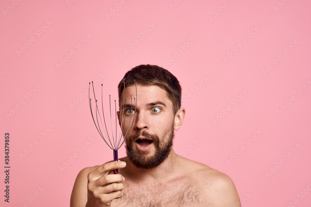 Obraz premium man with head massager relax body care pink background