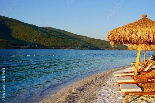 Bodrum, Russia - August, 2020: Beautiful tropical beach banner. White sand and coco palms travel tourism wide panorama background concept. Boost up color process. Luxury island resort vacation or