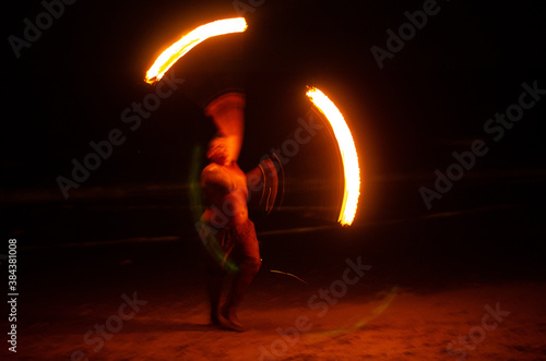 Man doing Fire Show at a beach bar