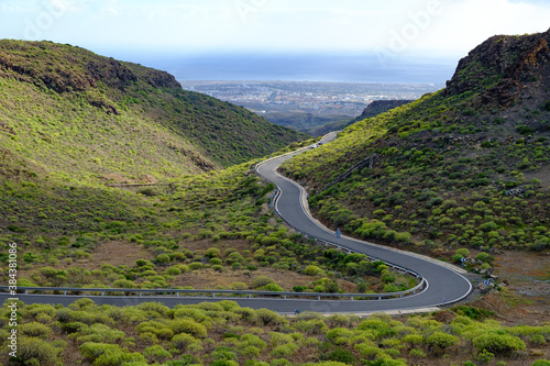 Windy road from mountains to the sea