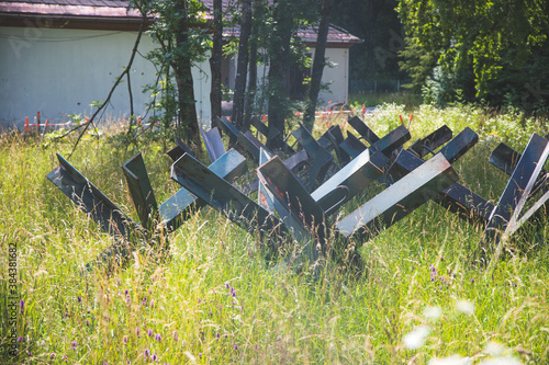 Close up of abandoned anti tank barrier in a savaged flower field photo