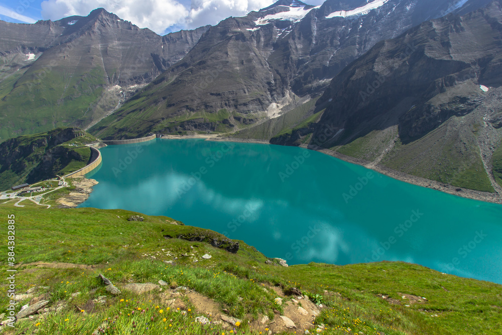 Beautiful view of high mountain lake near Kaprun.Hike to the Mooserboden dam in Austrian Alps.Quiet relaxation in nature.Wonderful nature landscape,turquoise tranquil lake,holiday travel scene.