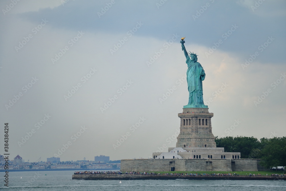 The Statue of Liberty in New York City. Statue of Liberty over hudson river on island. Landmarks of lower manhattan New York city.