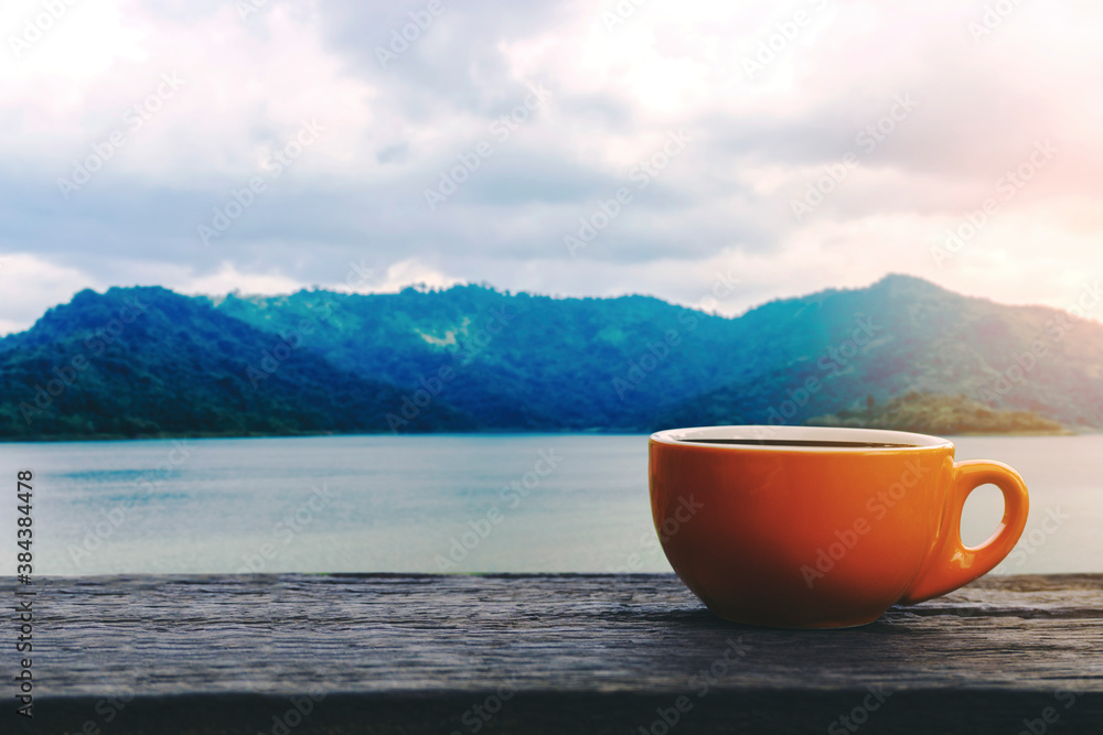 Hot Coffee cup on a table with a view mountain and water Hot Coffee cup on a table with a view mountain and water