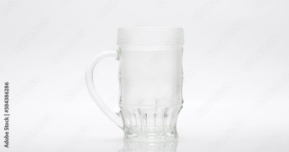 Beer Poured Into A Glass On A White Background Beer Poured Into A Glass On A White Background