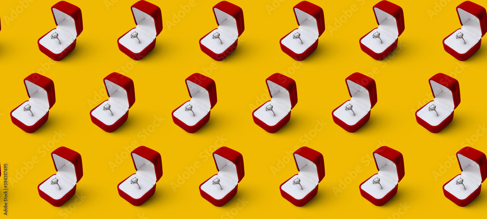 Seamless pattern on a yellow background. Opened red box with a silver ring with a precious stone. Gift. Jewelry store. Seamless pattern on a yellow background. Opened red box with a silver ring with a precious stone. Gift. Jewelry store.