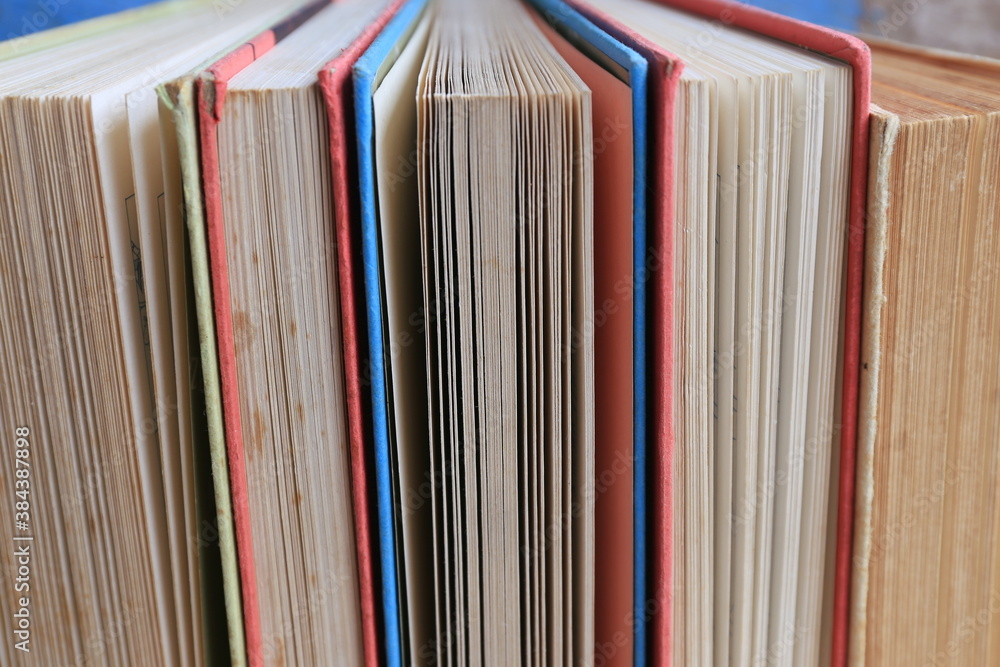 Close-up of old books arranged in the library Old wooden floor as background selective focus and shallow depth of field Close-up of old books arranged in the library Old wooden floor as background selective focus and shallow depth of field