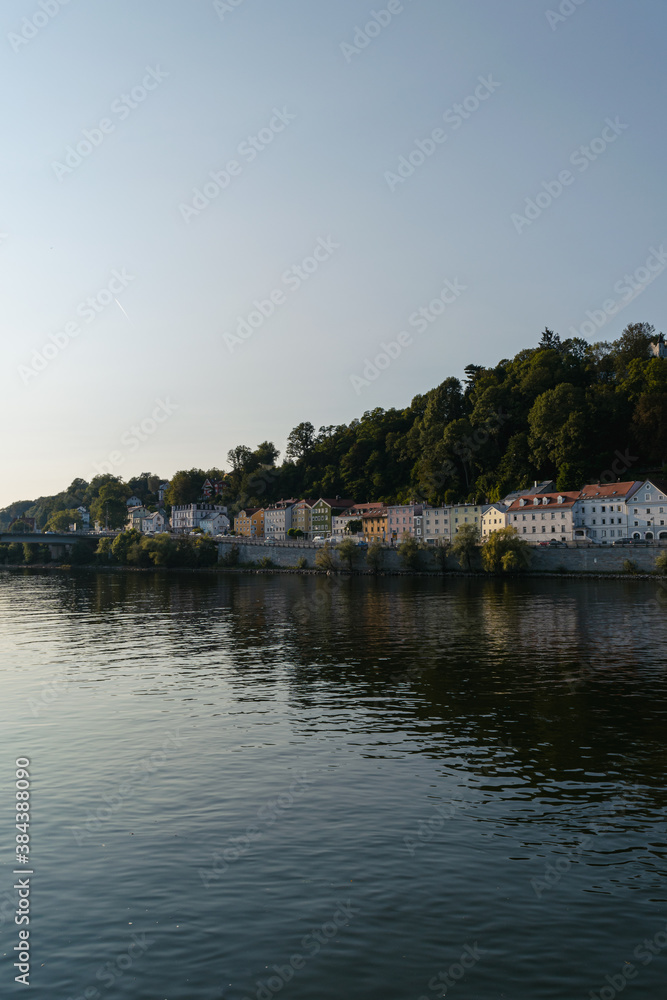 Houses' reflection on the Danube River in summer, Passau, Germany