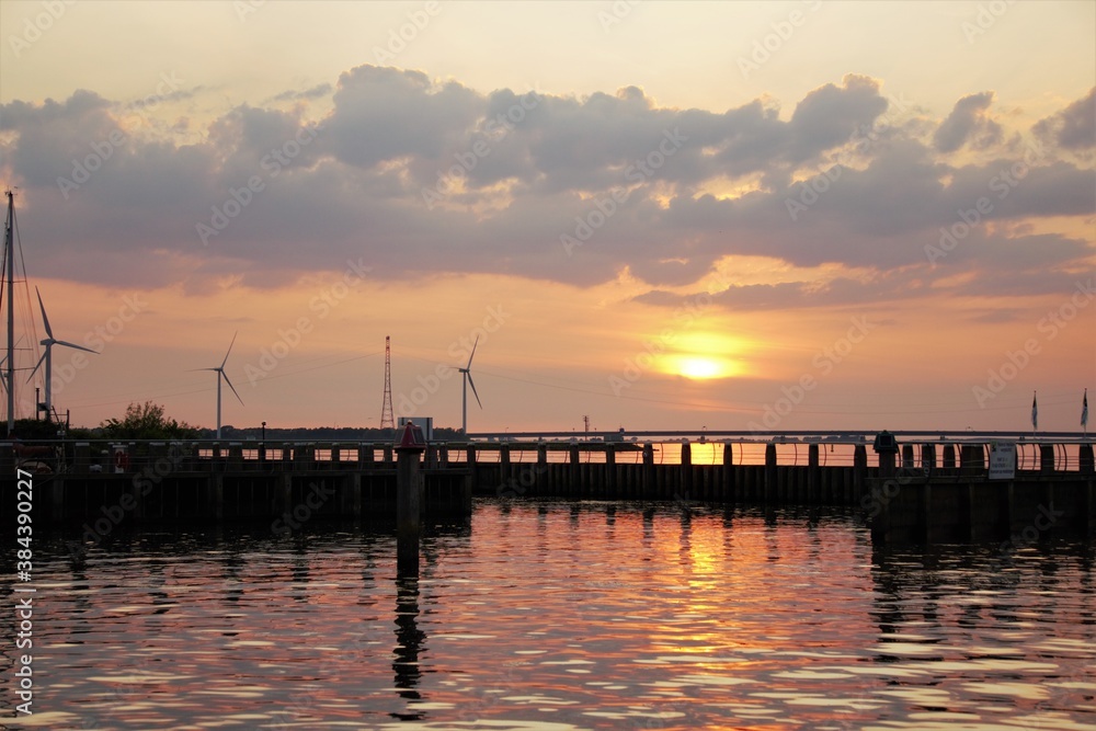 Obraz premium Sunset by the harbor entrance.