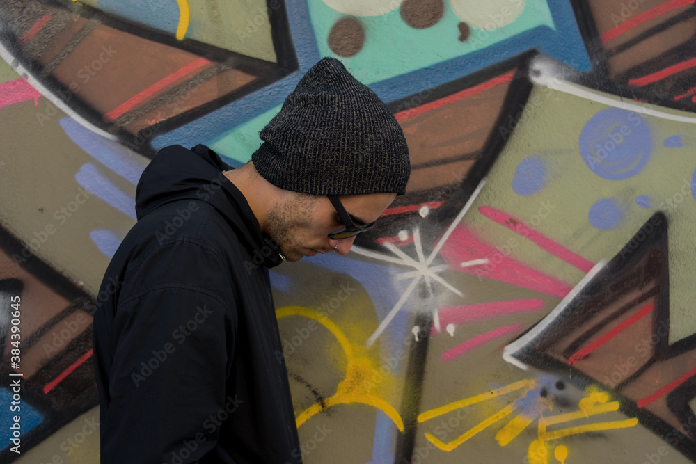 Young man in front of a colorful wall, positive concept, urban art, contrast, copy space, man campaign Young man in front of a colorful wall, positive concept, urban art, contrast, copy space, man campaign