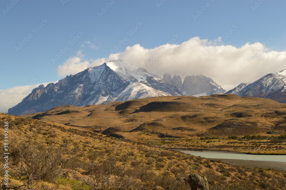 Hiking around the dramatic and windy mountain landscapes of Torres del Paine in Patagonia, Chile