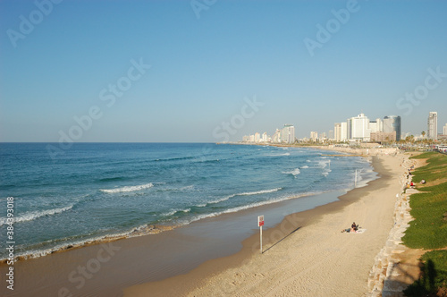 sandy beach, blue Mediterranean sea, urban landscape © Viktor