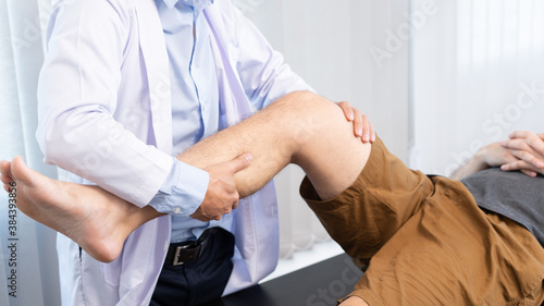 physiotherapist doctor rehabilitation consulting physiotherapy giving exercising knee treatment with patient in physio clinic or hospital.
