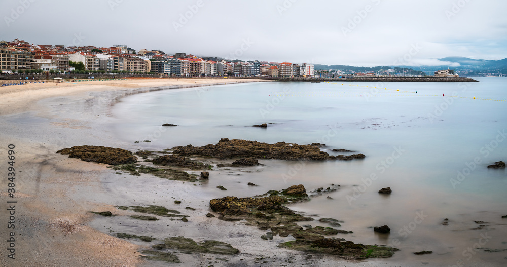 Panorama view of Sanxenxo and Silgar beach at the end of a cloudy Summer day in the Rias Baixas in Galicia, Spain.
