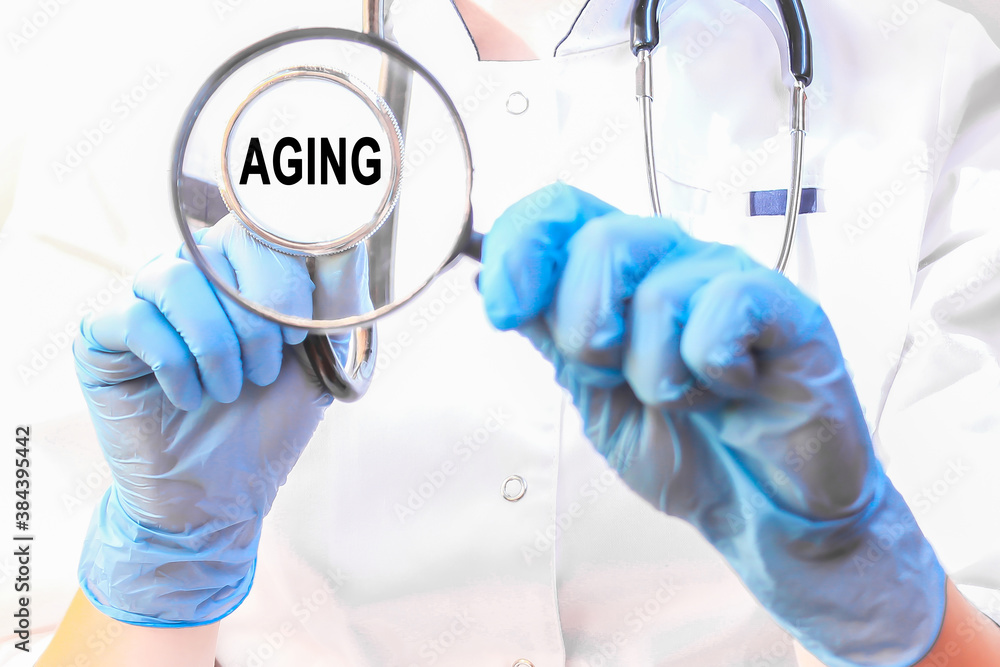 Doctor holding a card with text AGING, medical concept Doctor holding a card with text AGING, medical concept