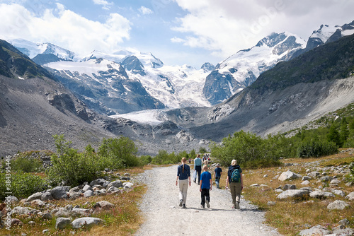 Morteratsch, Switzerland - July 22, 2020 : Tourists at Morteratsch Glacier trail photo