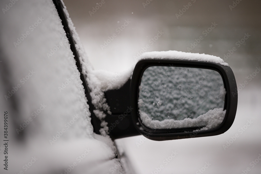 The beginning of spring. Unexpected snow covered cars and roads. Door mirror and glass of a car in the snow. Winter does not want to leave. Road safety The beginning of spring. Unexpected snow covered cars and roads. Door mirror and glass of a car in the snow. Winter does not want to leave. Road safety