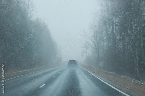 a car on the road in the snowstorm