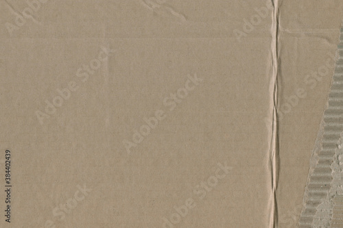 Close up of a light brown vintage rough sheet of carton. Cardboard paper texture with a blank background. Empty papercraft surface. Recycled environmentally friendly material.