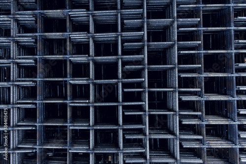 Steel mesh for construction Steel Rebars for reinforced concrete. Steel reinforcement bar texture in construction site.