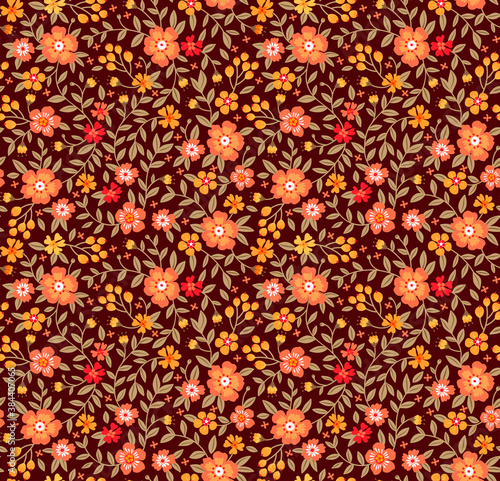 Beautiful floral pattern in small abstract flowers. Small orange flowers. Brown background. Ditsy print. Floral seamless background. The elegant the template for fashion prints.