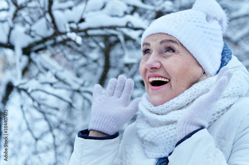 Happy beautiful senior woman in warm hat