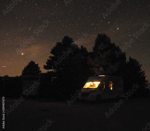 Camper van in the mountains with star