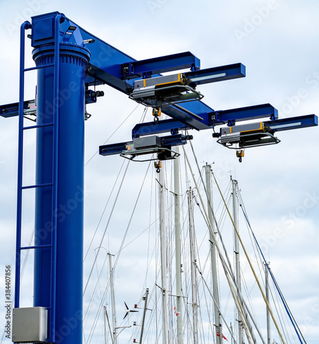 Blue heavy lift boat crane at the marina, ready to lift boats in and out of the water for maintenance.  photo