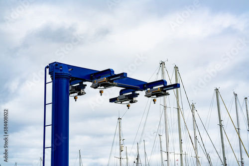 Blue heavy lift boat crane at the marina, ready to lift boats in and out of the water for maintenance.  photo