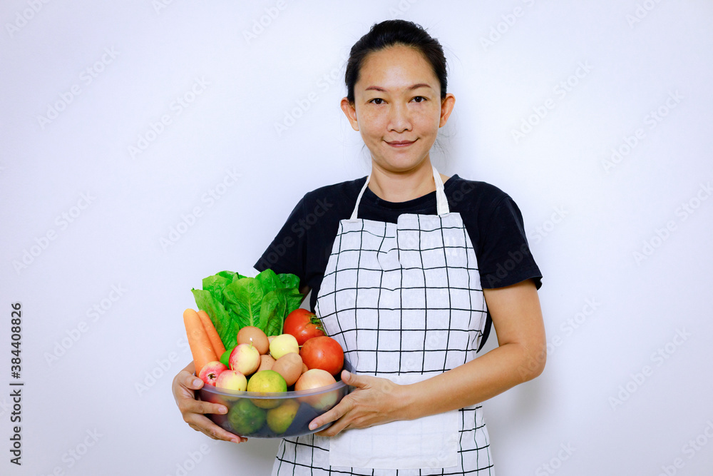 Asian Woman Standing Smile and Holding Mix Freshness Vegetables Box. Home Food Cooking and Housework Concept. Asian Woman Standing Smile and Holding Mix Freshness Vegetables Box. Home Food Cooking and Housework Concept.
