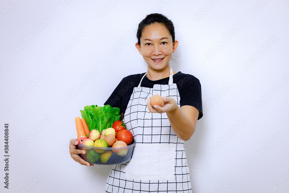 Asian Woman Standing Smile and Holding Mix Freshness Vegetables Box. Home Food Cooking and Housework Concept. Asian Woman Standing Smile and Holding Mix Freshness Vegetables Box. Home Food Cooking and Housework Concept.