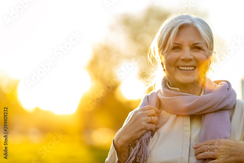 Senior woman enjoying autumn colors at sunset
 photo