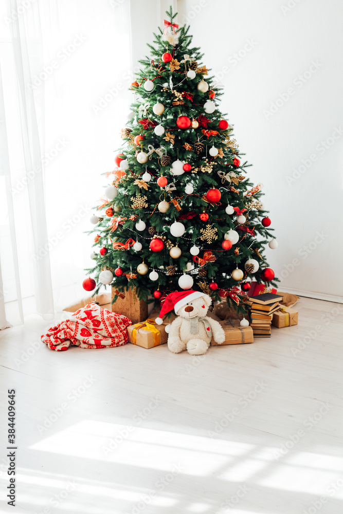 Christmas tree by the window with gift decor for the new year interior of the holiday house