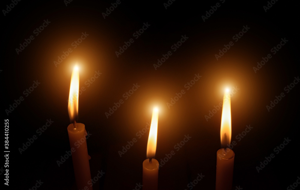 The lighting candles, Burning candle on black background, Candlelit in the dark, Candle flame at night. Lighting design for the background. Candle in the dark, Design for the background. The lighting candles, Burning candle on black background, Candlelit in the dark, Candle flame at night. Lighting design for the background. Candle in the dark, Design for the background.