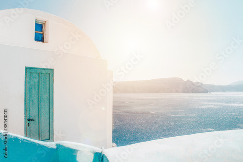 House in the mountain overlooking the sea and volcan in a sunrise oia santorini greece