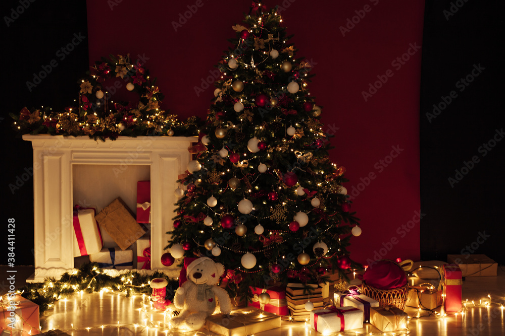 Christmas tree shines lights garlands New Year's Night Red Wall