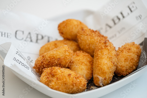 Tapas plate of Spanish ham and cheese croquettes with onions