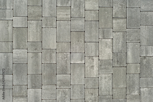 Cobblestone texture. The sidewalk tile is evenly folded. Gray cobblestones close up. photo