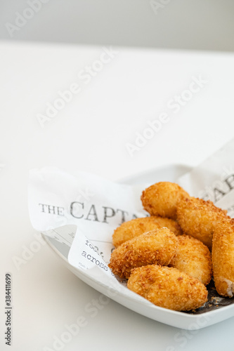 Tapas plate of Spanish ham and cheese croquettes with onions