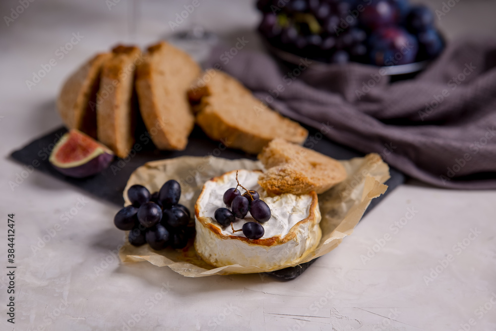 brie cheese with grapes, figs. Bread with cheese. camembert cheese. Atmospheric breakfast