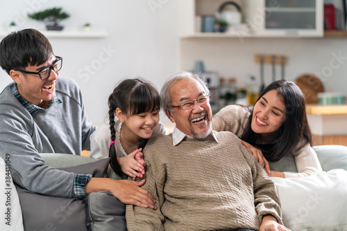 Happy multigenerational asian family portrait in living room photo