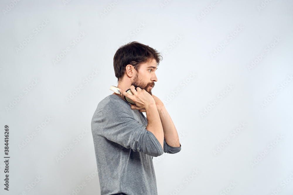 Man with headphones music lifestyle emotions technology modern style leisure entertainment light background Man with headphones music lifestyle emotions technology modern style leisure entertainment light background