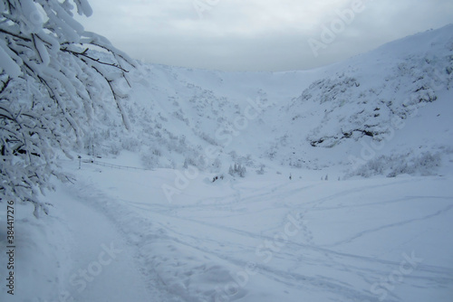 A snowy mountain trail on a gloomy day
