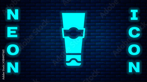 Glowing neon Tube of toothpaste icon isolated on brick wall background. Vector.