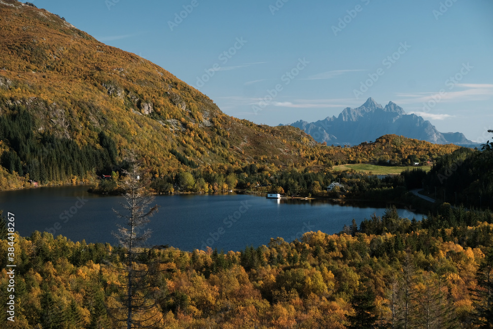Uninhabited Lofoten Islands during Covid-19 pandemic situation in autumn. No tourists and very quiet and peaceful fall mood. Lake with reflection and spectacular mountains covered by fresh snow.
