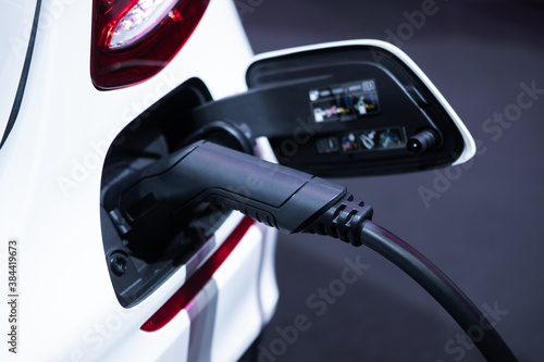 Electric vehicle charging port plugging in EV modern car. save ecology alternative energy sustainable of future