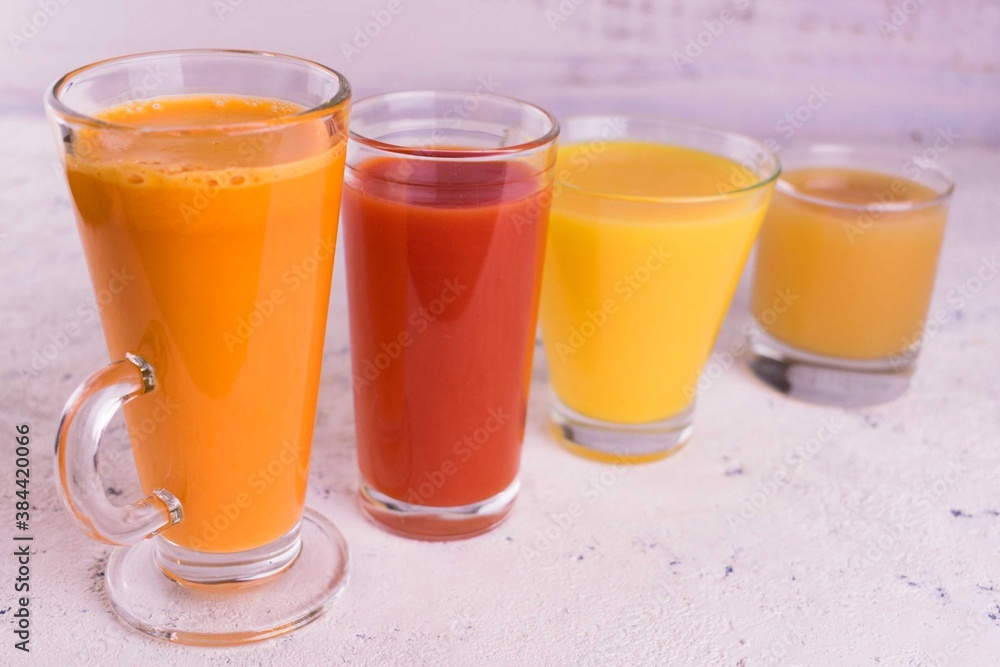 Glasses with fruit and vegetable juices on a white background. Glasses with fruit and vegetable juices on a white background.